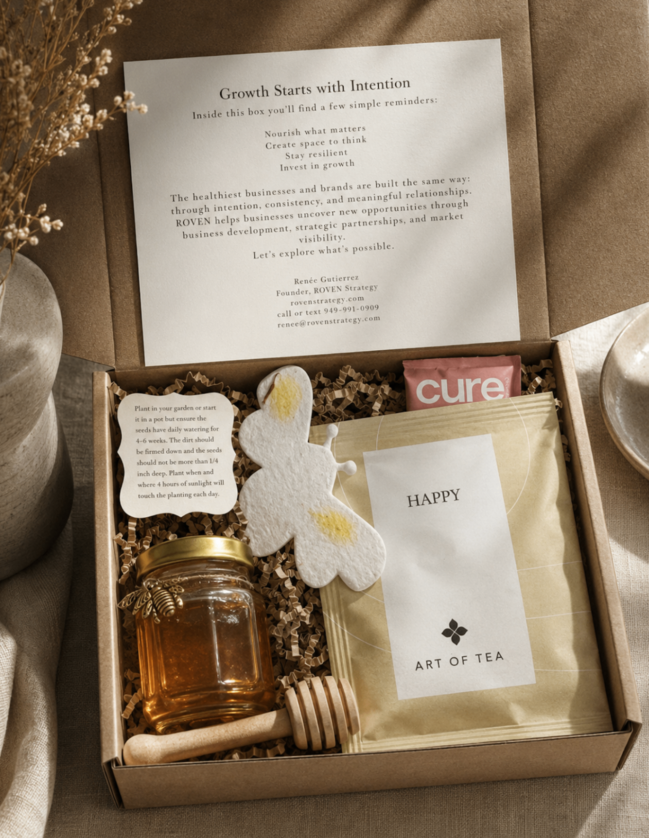 Opened ROVEN Reserve gift box with curated honey, tea, and seed paper inside